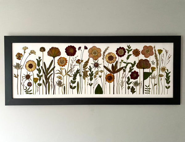 Framed artwork of stylized floral design on a white background